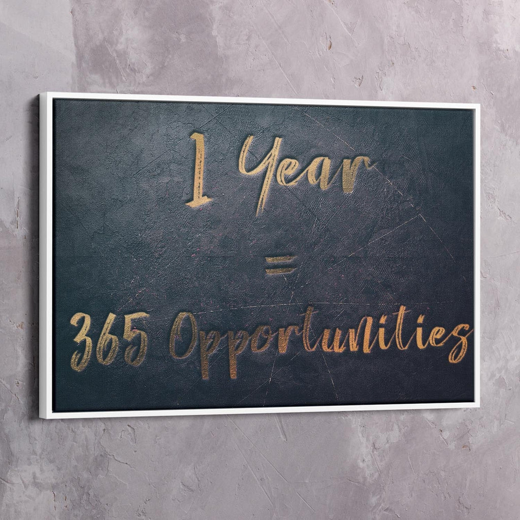 White-framed dark blue wall art reading “1 Year = 365 Opportunities” in gold