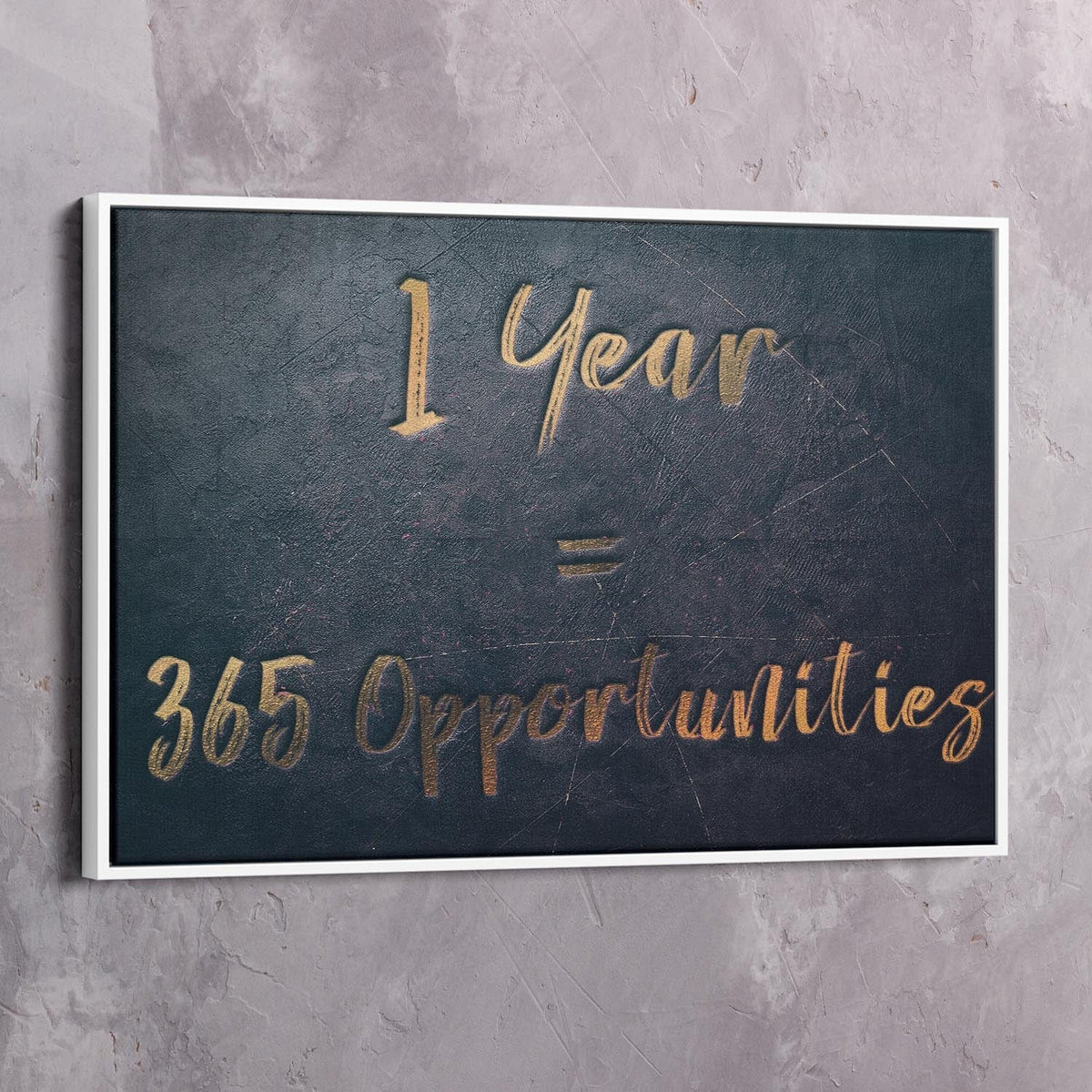 White-framed dark blue wall art reading “1 Year = 365 Opportunities” in gold