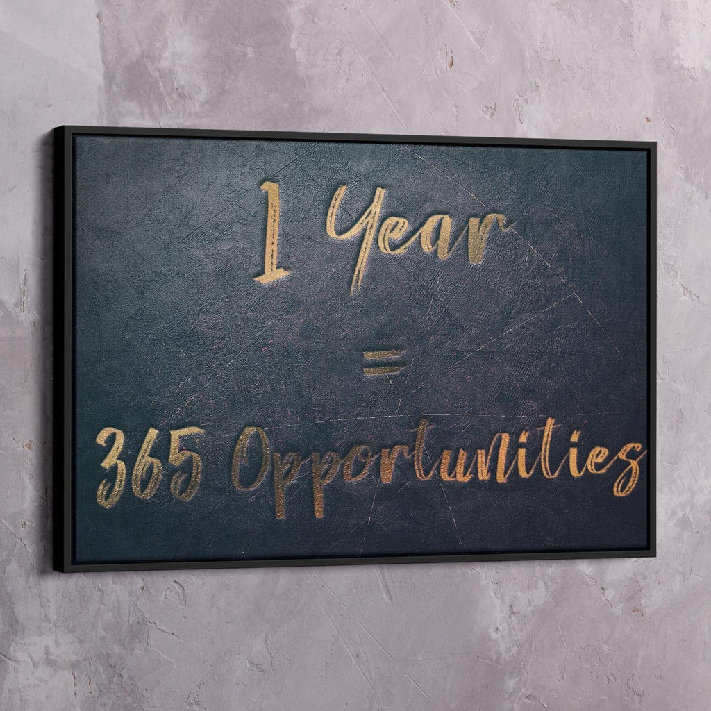 Black-framed dark blue wall art reading “1 Year = 365 Opportunities” in gold