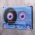 Blue cassette tape wall art with pink reels and quote text, clear corner mounting