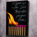 Black motivational wall art with flaming matches and cursive quote, canvas portrait