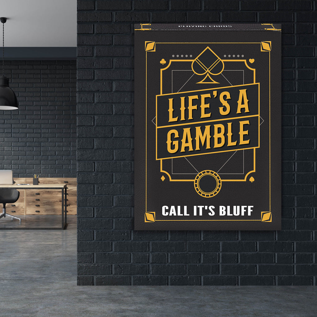 Hanging black wall art with gold playing-card design and text 'LIFE'S A GAMBLE' 'CALL IT'S BLUFF'