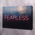 Motivational wall art canvas with neon red "FEARLESS" over blue ocean ripples