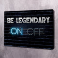 Motivational wall art canvas, angled view: 'BE LEGENDARY' and 'ON OFF' neon on dark brick