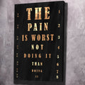 Portrait wall art canvas with black background, gold text 'THE PAIN IS WORST NOT'.