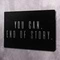 Black motivational wall art canvas with "YOU CAN. END OF STORY." text.